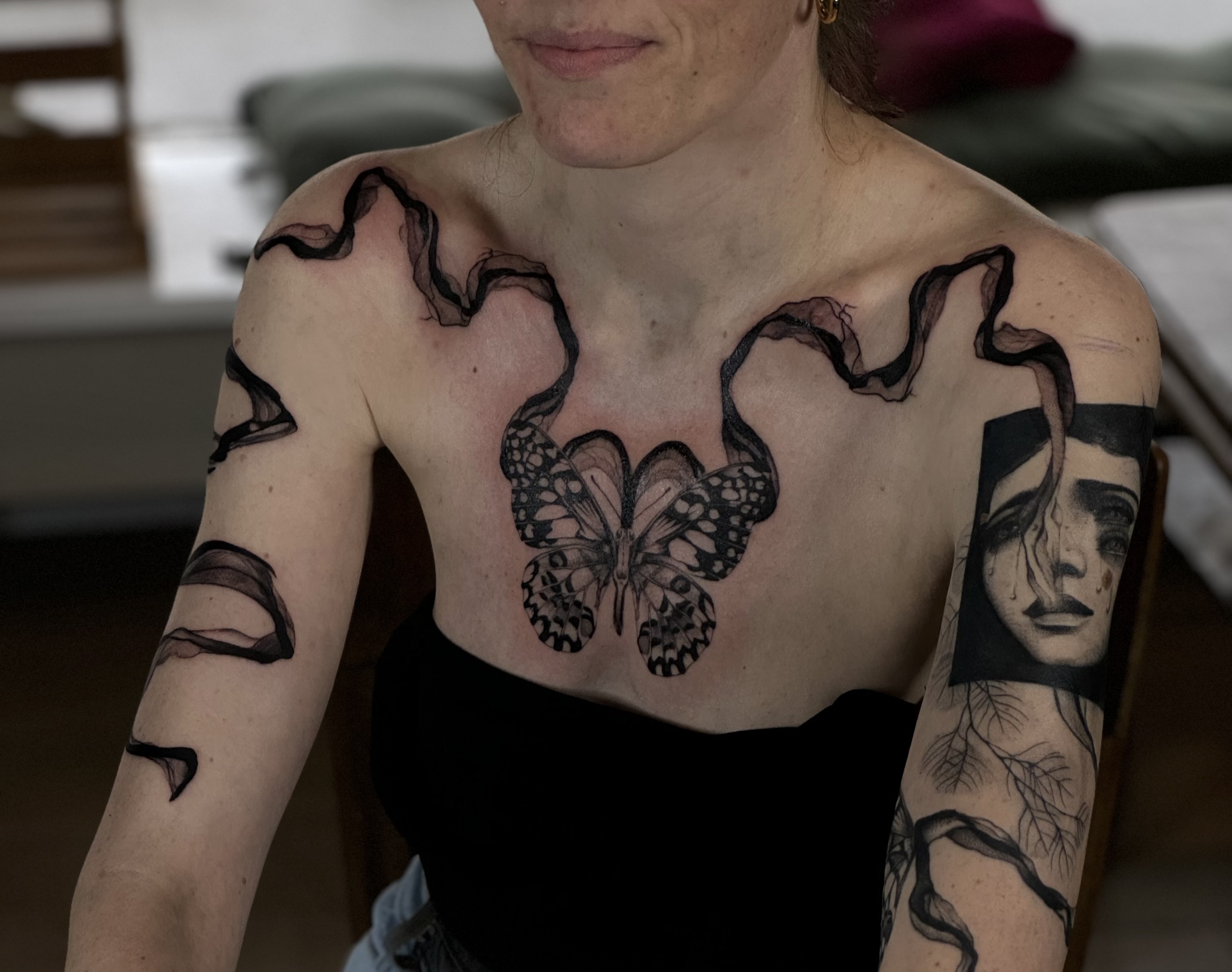 Butterfly and abstract tattoo art by Noa Jordan